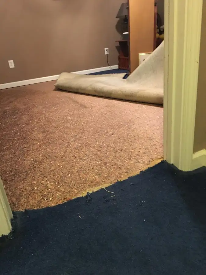 Carpet pad removal revealing water damage during Water Mitigation Services in Southlake